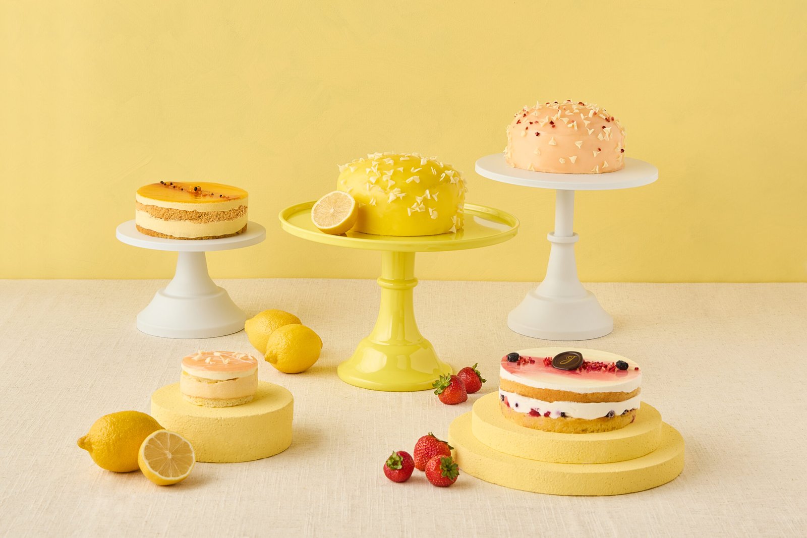 Cakes and pastries on yellow cake stands