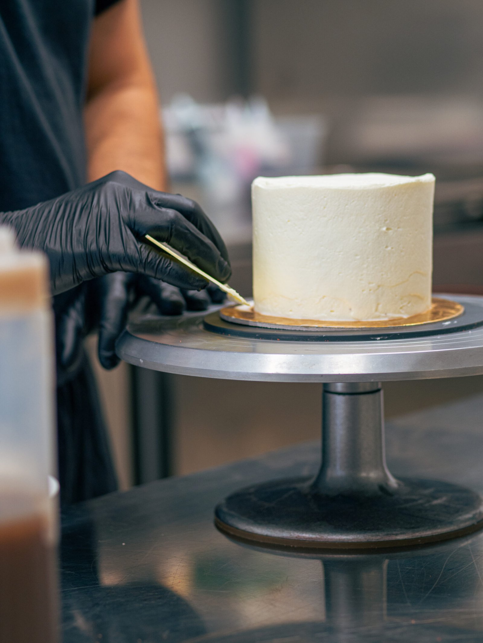 Pastry chef glazing a cake